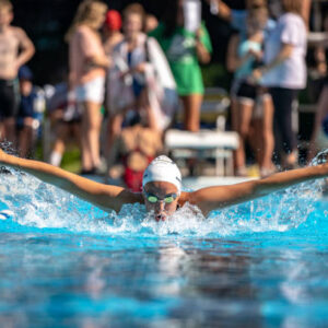 girls swimming butterfly at a summer swim meet